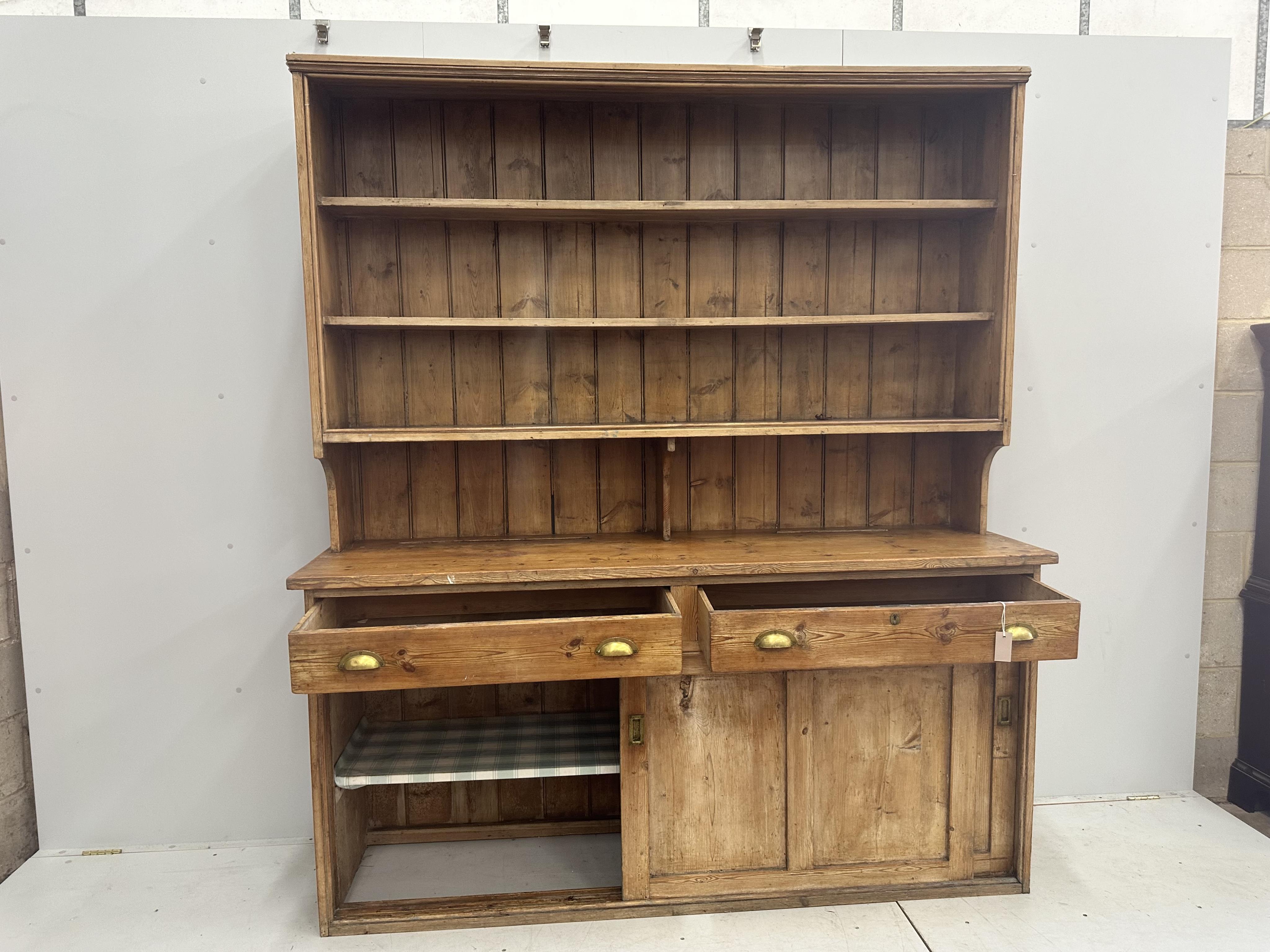 A Victorian pine dresser with boarded rack, width 189cm, depth 51cm, height 216cm. Condition - poor to fair